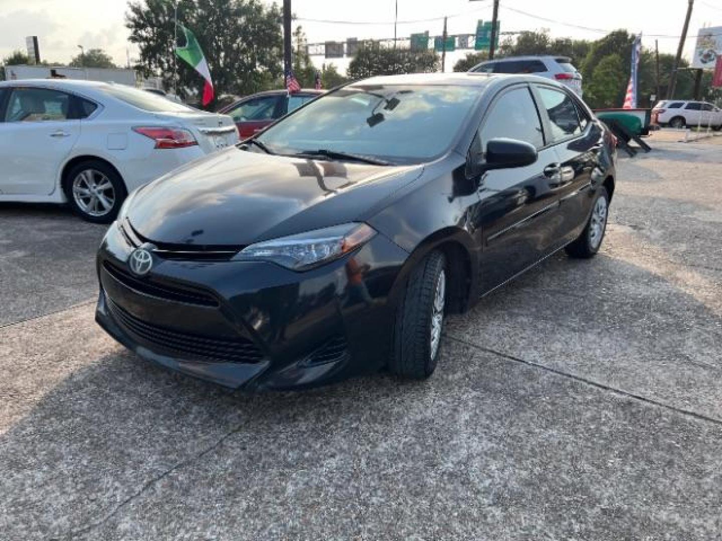 2017 Black Sand Pearl /Ash/Dark Gray Fabric, premium cloth Toyota Corolla LE CVT (5YFBURHE5HP) with an 1.8L L4 DOHC 16V engine, Continuously Variable Transmission transmission, located at 7935 Gulf Freeway, Houston, 77017, (832) 266-1645, 29.684393, -95.275665 - Photo#2