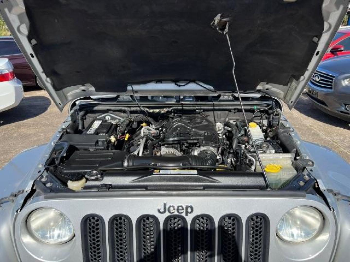 2012 Bright Silver Metallic with Black Soft Top Jeep Wrangler Sahara 4WD (1C4AJWBG1CL) with an 3.6L V6 DOHC 24V FFV engine, 5-Speed Automatic transmission, located at 7935 Gulf Freeway, Houston, 77017, (832) 266-1645, 29.684393, -95.275665 - Photo#14