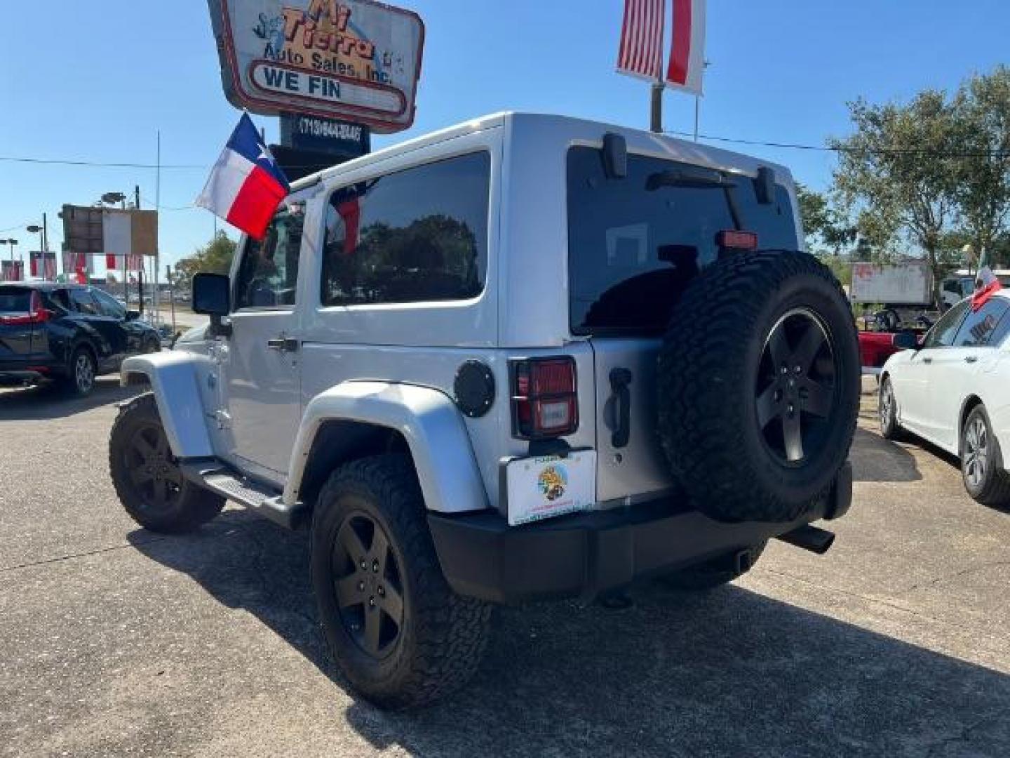 2012 Bright Silver Metallic with Black Soft Top Jeep Wrangler Sahara 4WD (1C4AJWBG1CL) with an 3.6L V6 DOHC 24V FFV engine, 5-Speed Automatic transmission, located at 7935 Gulf Freeway, Houston, 77017, (832) 266-1645, 29.684393, -95.275665 - Photo#4