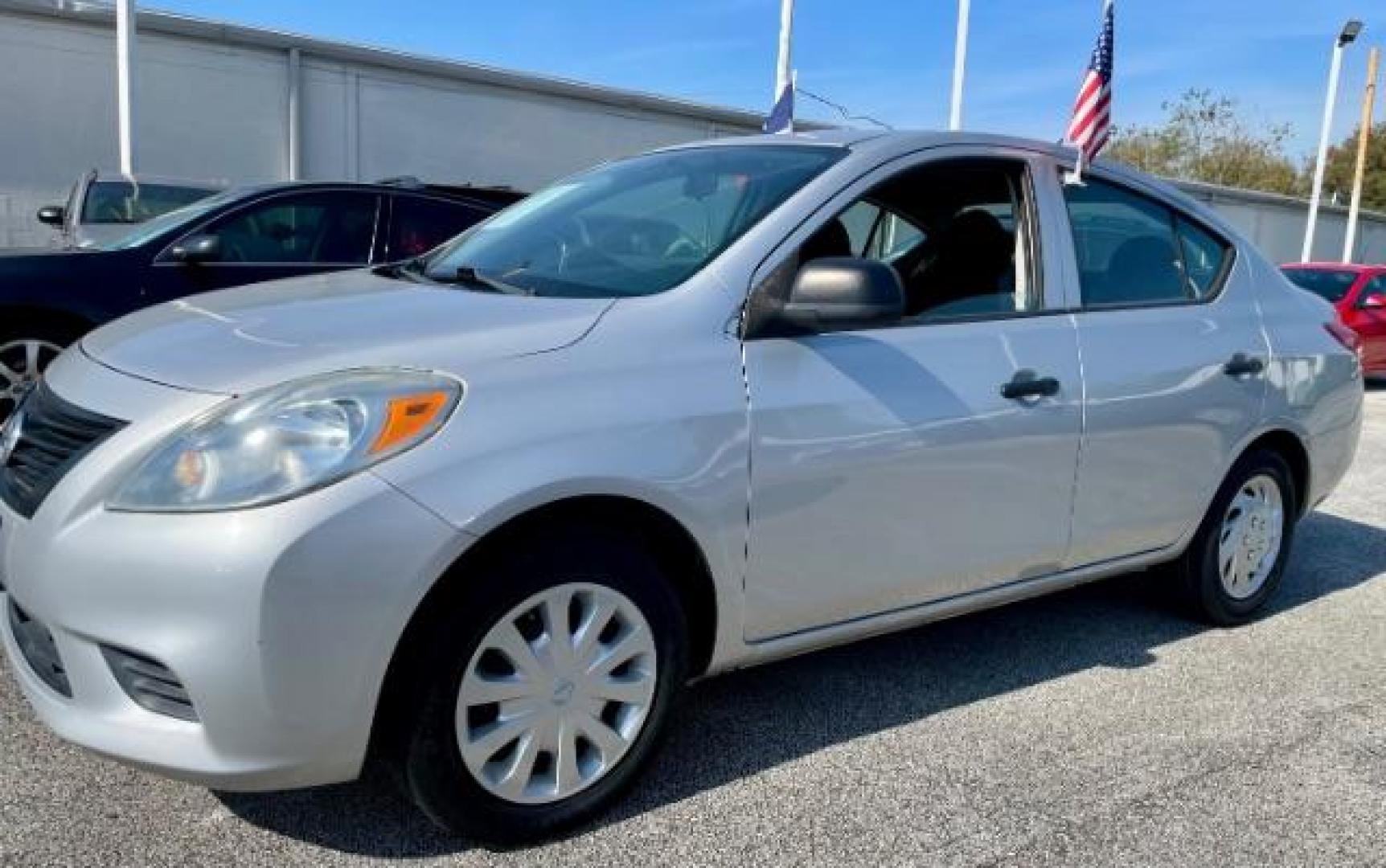 2013 Magnetic Gray /Charcoal Nissan Versa 1.6 S 5M (3N1CN7AP6DL) with an 1.6L L4 DOHC 16V engine, 5-Speed Manual transmission, located at 4545 Spencer Hwy., Pasadena, 77504, (832) 266-1645, 29.666037, -95.173775 - Photo#0